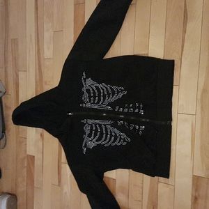 Black zip up hoodie with skeleton drawings made out of jems